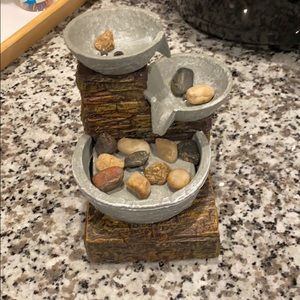 Battery powered waterfall with rocks.